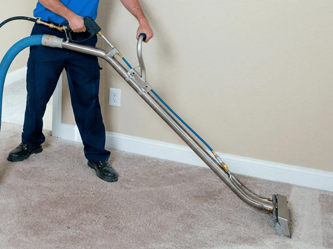 Professional operating a liquid removal machine on a carpeted floor in Wilmington, NC